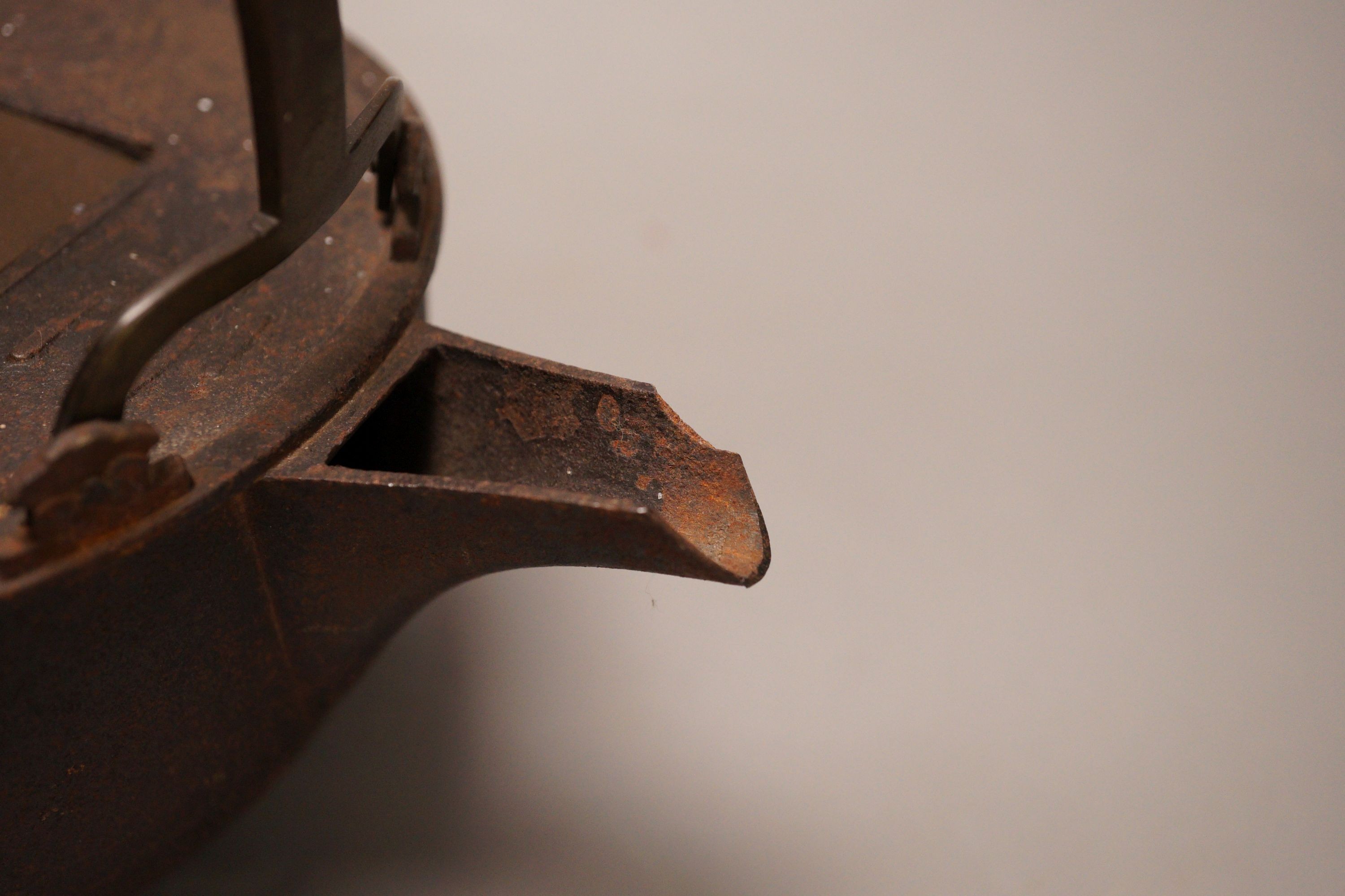 A Japanese cast iron and bronze teapot on tripod stand, inscribed, 19cm wide including spout